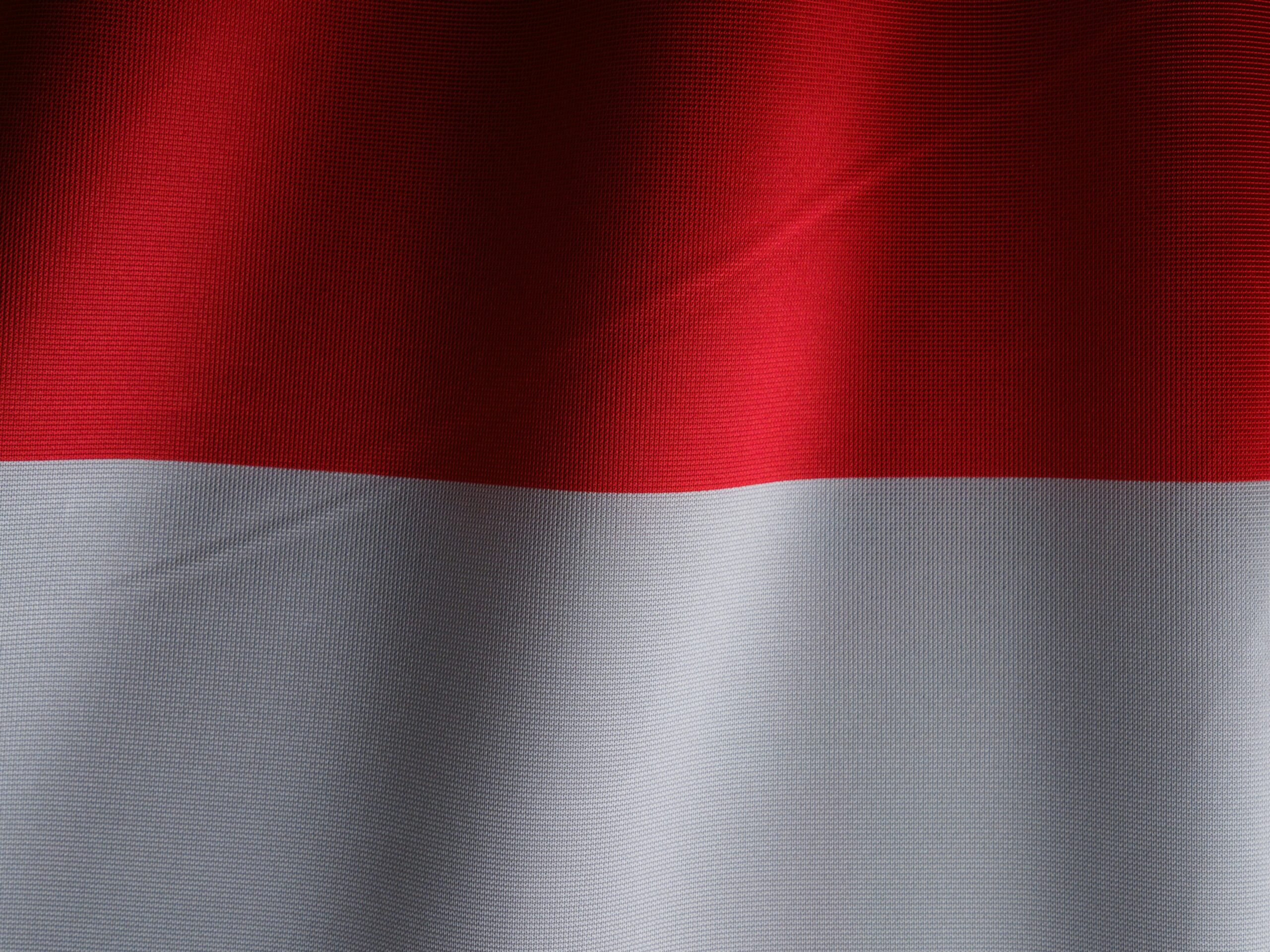 Detailed view of the red and white Indonesian flag waving in the wind.